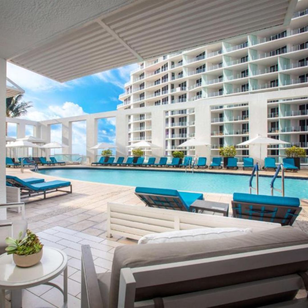 Hotel outdoor pool with blue deck chairs